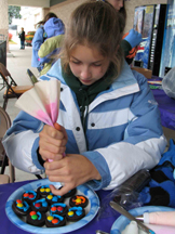 A volunteer decorates cookies